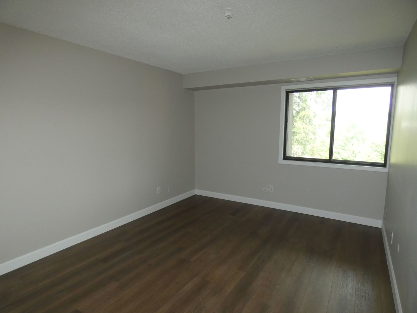 1501 Woodbridge Road, Unit 3C Joliet, IL 60436 - Photo 10 of 24 a view of an empty room with wooden floor and a window