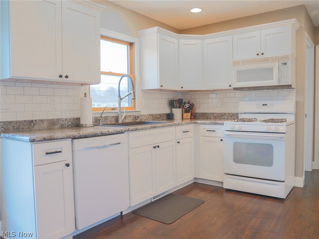 4993 Emalene Road Wooster, OH 44691 - Photo 12 of 30 Kitchen featuring white cabinets, white appliances, backsplash, and dark wood-type flooring