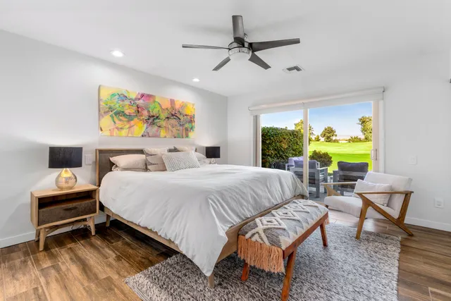 a bedroom with a bed a dresser and a window