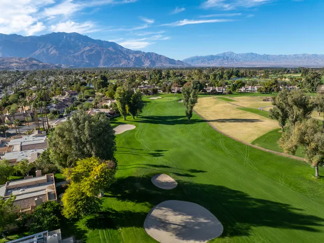 a view of a lush green hillside and houses