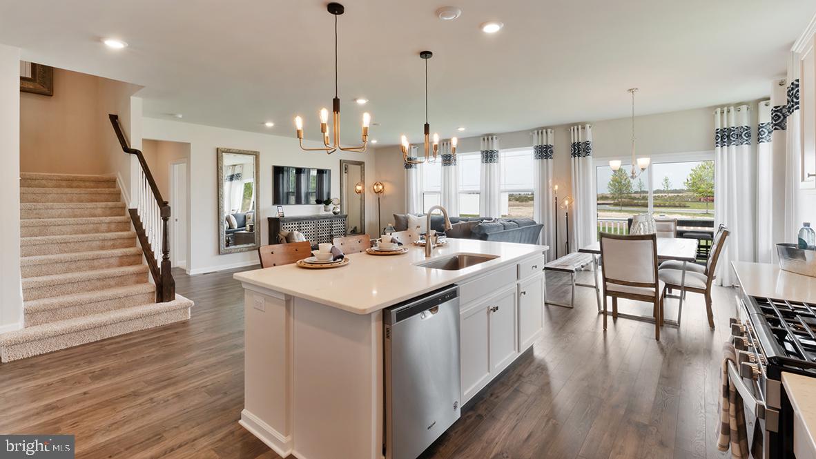 22 Georgetown Drive Freehold, NJ 07728 - Photo 11 of 24 a kitchen with stainless steel appliances kitchen island a large island in the center and wooden floors