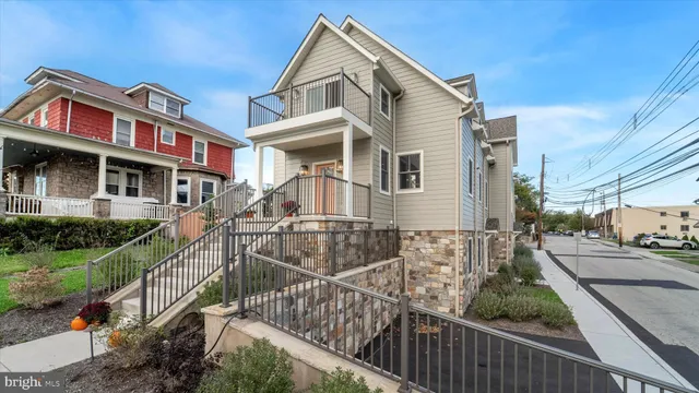 a view of a house with wooden fence