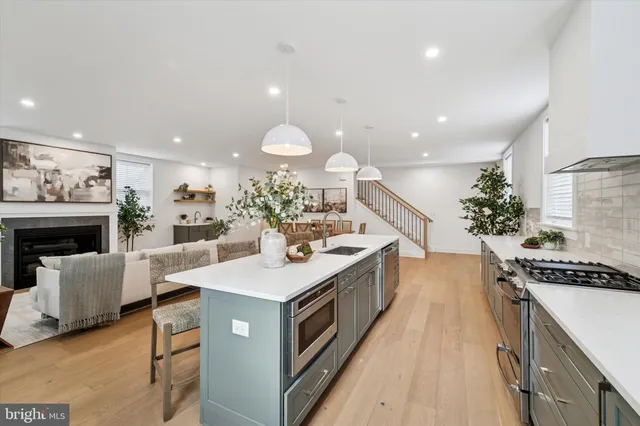 a kitchen with a sink stove and cabinets