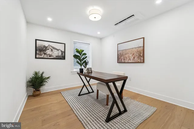 a workspace room with furniture and wooden floor