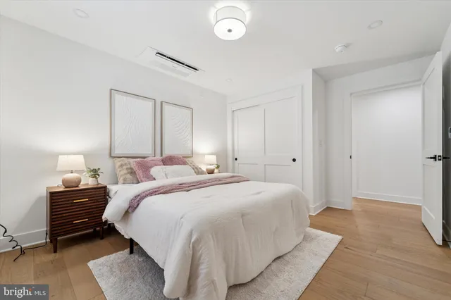 a bedroom with a bed and a lamp