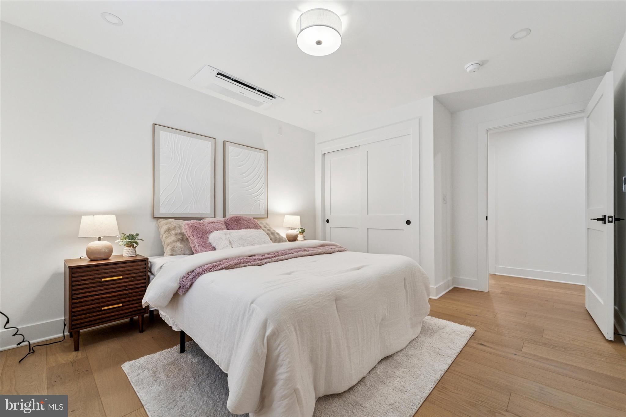 25 North Ridge Avenue, Unit A Ambler, PA 19002 - Photo 18 of 26 a bedroom with a bed and a lamp