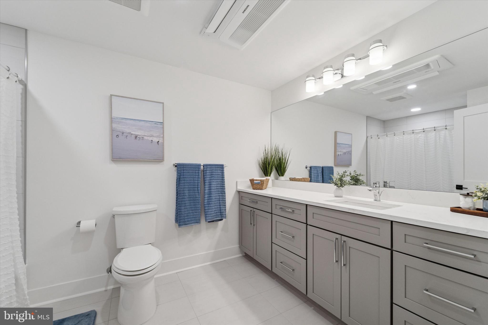 25 North Ridge Avenue, Unit A Ambler, PA 19002 - Photo 19 of 26 a bathroom with a double vanity sink toilet and a mirror