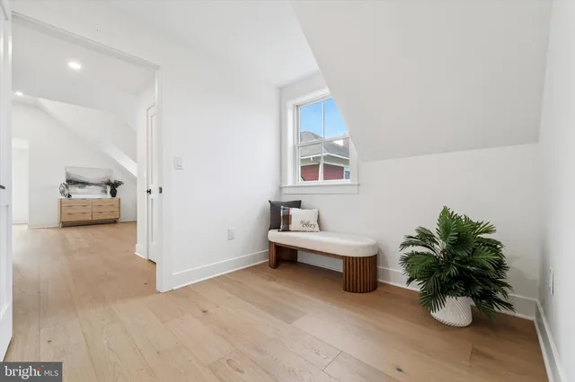 a view of a room with wooden floor and potted plant