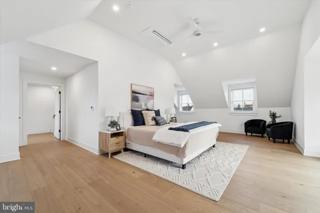 a spacious bedroom with a bed and a couch