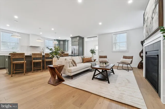 a living room with furniture a large window and a fireplace