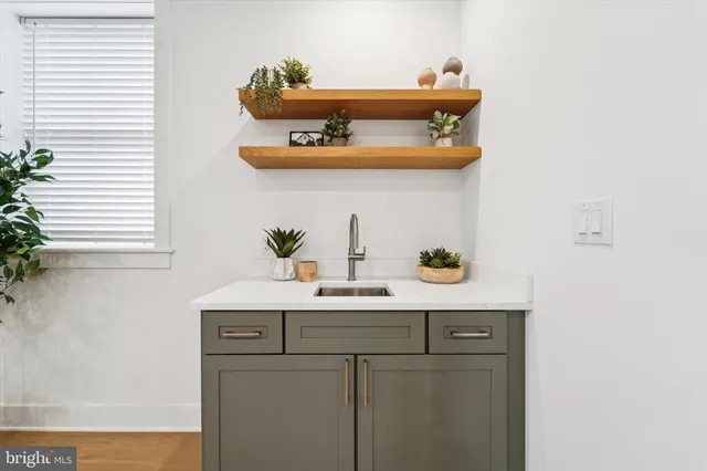 a room with a sink and cabinets