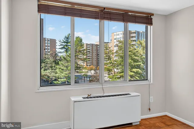 a bathroom with a granite countertop sink and a window