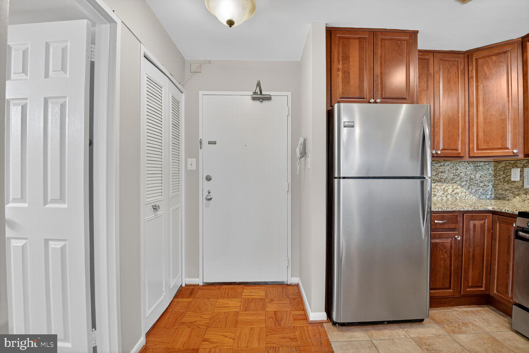 2939 Van Ness Street Northwest, Unit 941 Washington, DC 20008 - Photo 17 of 42 a view of hallway with cabinets and stainless steel appliances