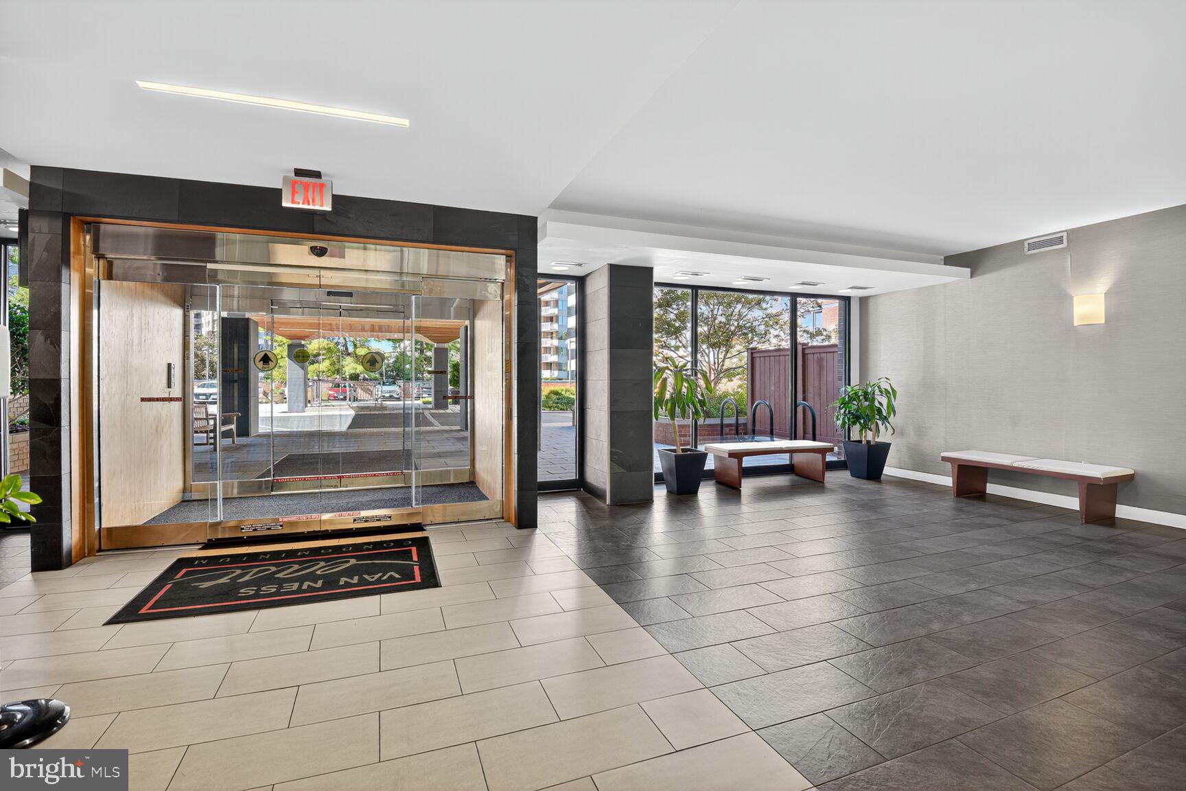 2939 Van Ness Street Northwest, Unit 941 Washington, DC 20008 - Photo 30 of 42 a lobby with furniture and floor to ceiling window