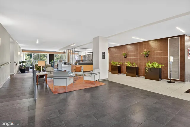 a view of a living room with furniture and kitchen view