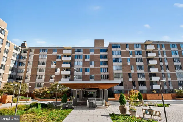 a front view of multi story residential apartment building with a outdoor space