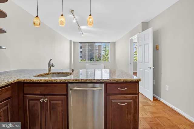 a kitchen with granite countertop a sink and a window
