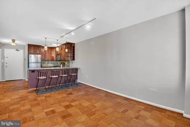 a view of kitchen with stainless steel appliances cabinets