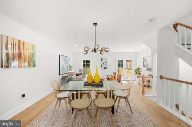 a view of a dining room with furniture and chandelier