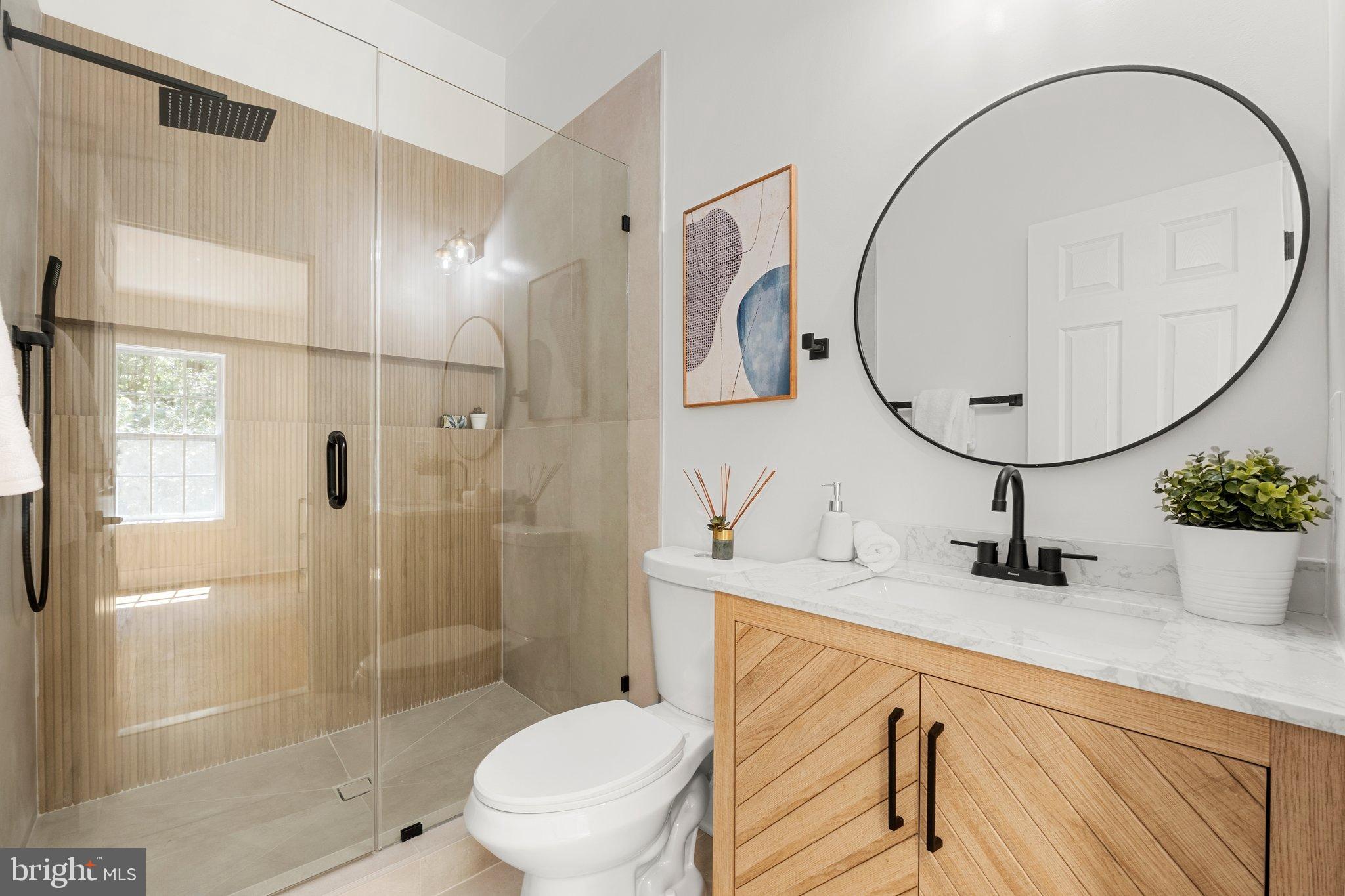 6213 Manchester Way Elkridge, MD 21075 - Photo 16 of 31 a bathroom with a sink a mirror a toilet and shower