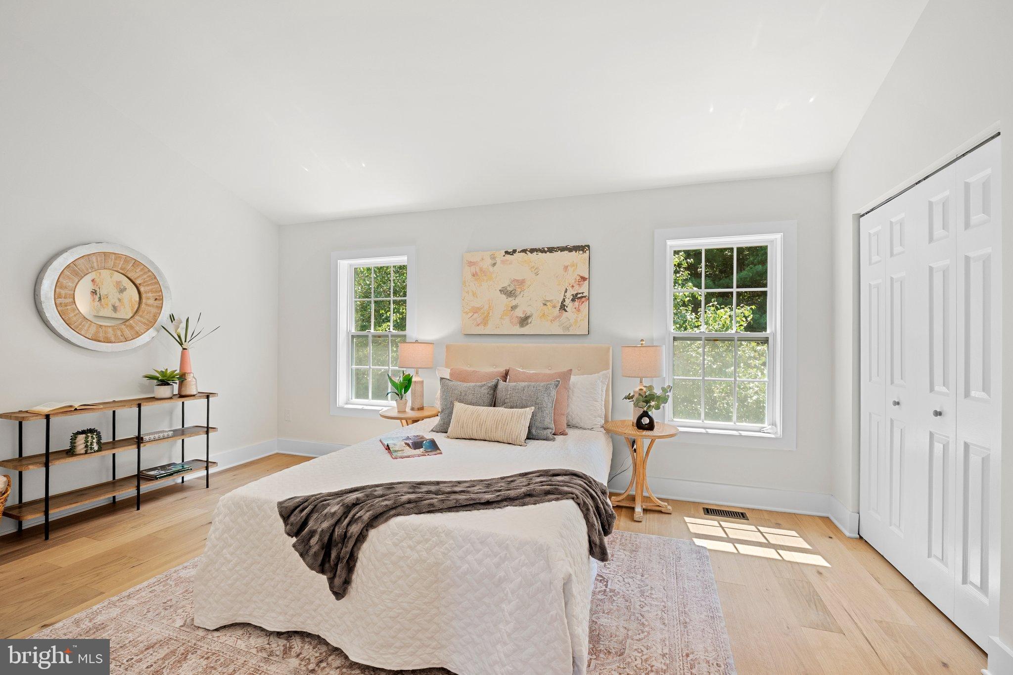 6213 Manchester Way Elkridge, MD 21075 - Photo 17 of 31 a bedroom with a bed a window and a chandelier
