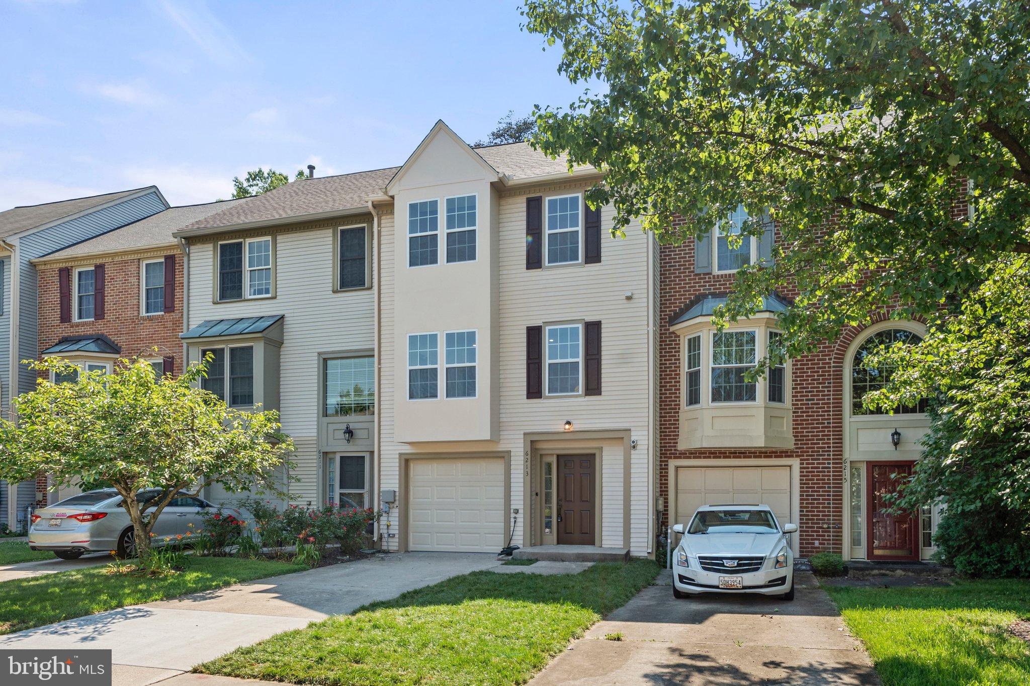 6213 Manchester Way Elkridge, MD 21075 - Photo 2 of 31 a front view of a house with a garden and trees