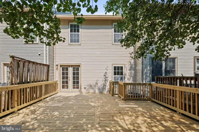 a view of a house with wooden fence and a porch