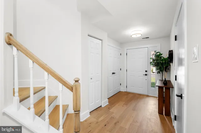 a view of hallway with wooden floor and stairs