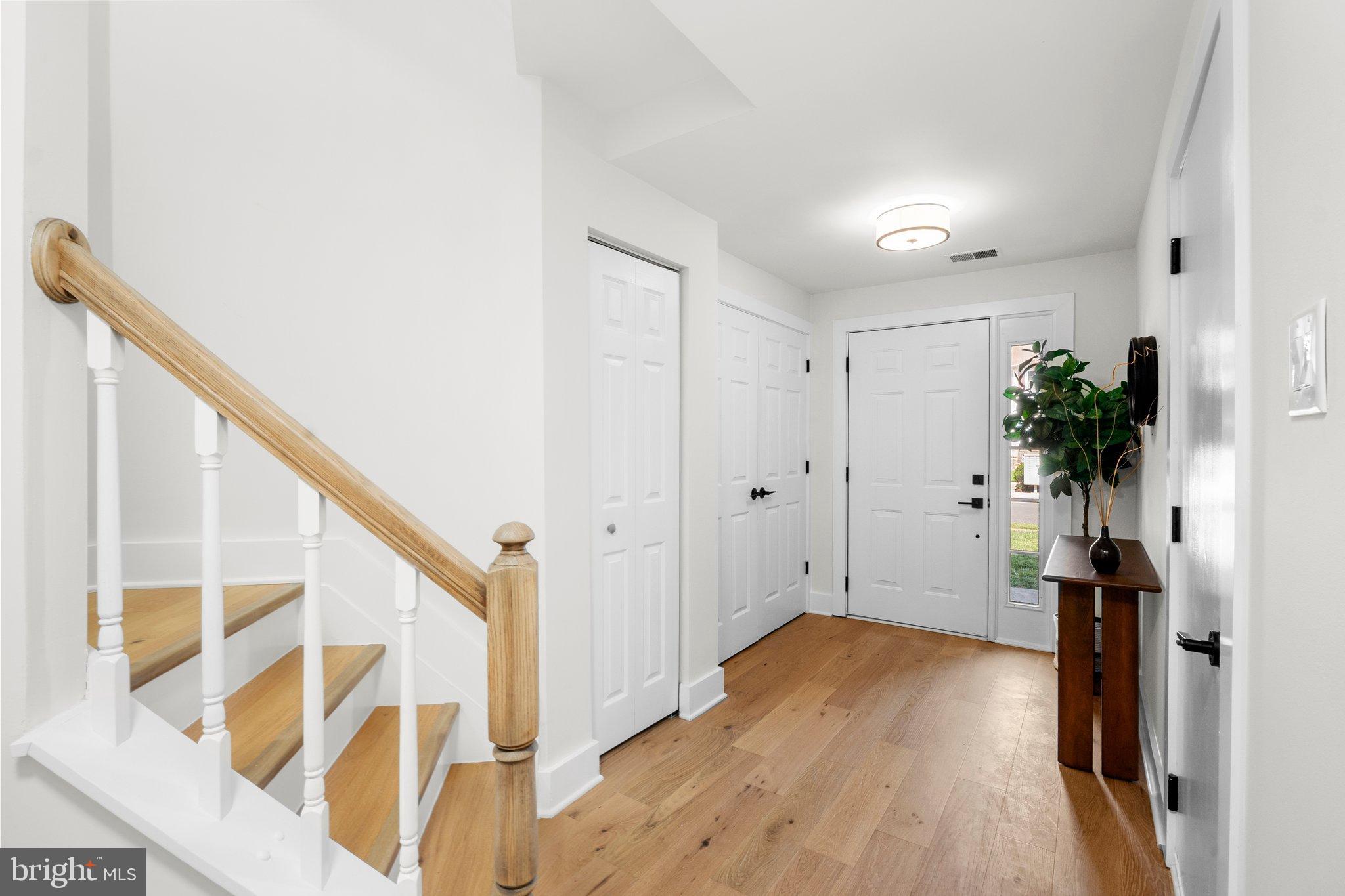 6213 Manchester Way Elkridge, MD 21075 - Photo 4 of 31 a view of hallway with wooden floor and stairs