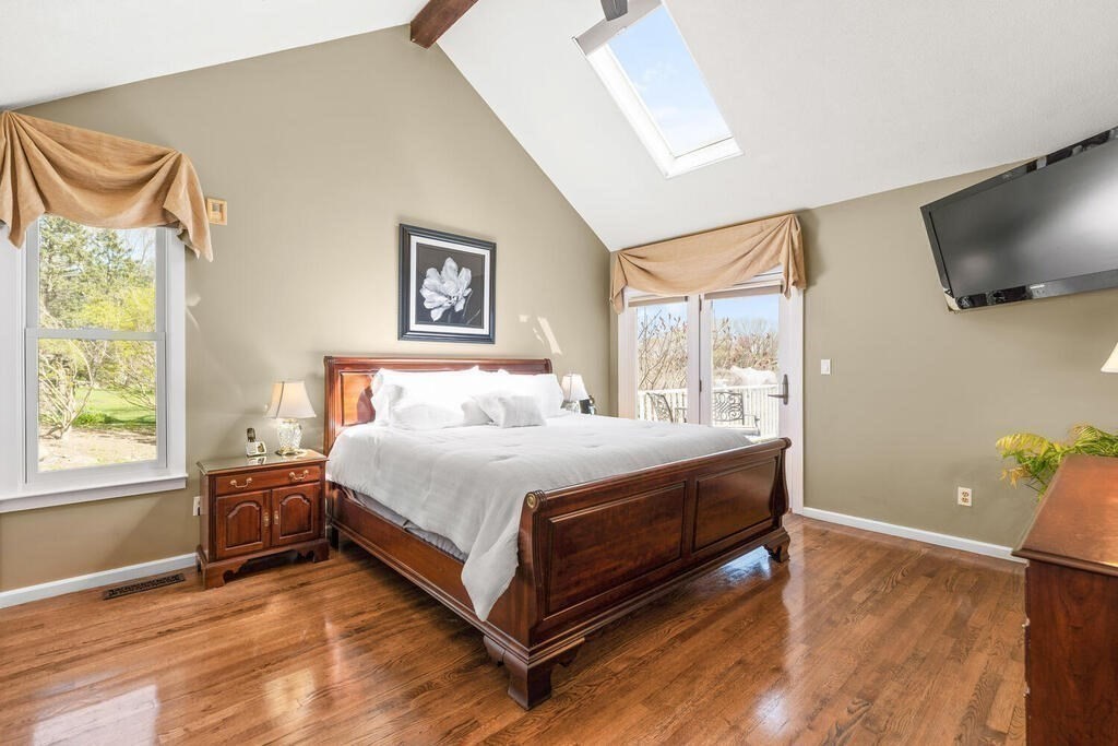 164 Marrett Road Lexington, MA 02421 - Photo 13 of 41 a spacious bedroom with a bed and a flat screen tv
