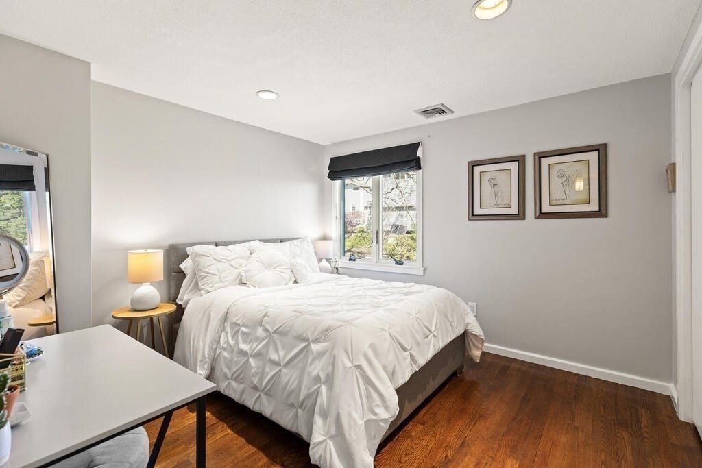 164 Marrett Road Lexington, MA 02421 - Photo 16 of 41 a bedroom with a bed and a table in it