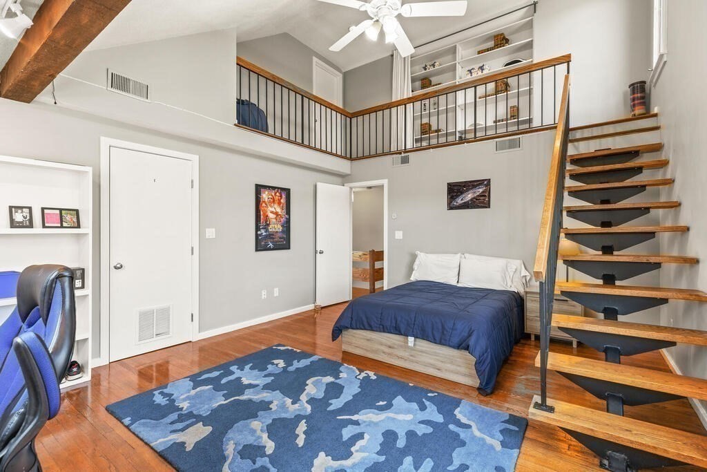 164 Marrett Road Lexington, MA 02421 - Photo 18 of 41 a bedroom with a bed and a book shelf