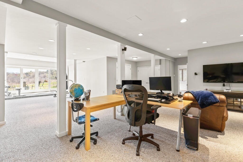 164 Marrett Road Lexington, MA 02421 - Photo 21 of 41 a view of a livingroom with workspace and a flat screen tv