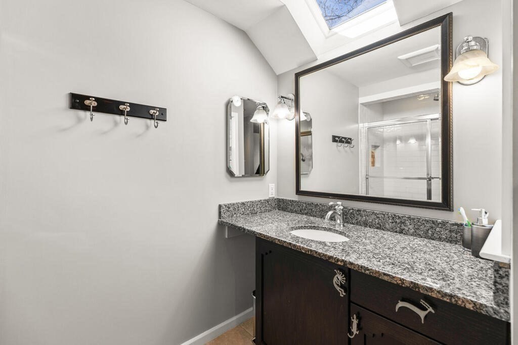 164 Marrett Road Lexington, MA 02421 - Photo 23 of 41 a bathroom with a granite countertop sink and a mirror