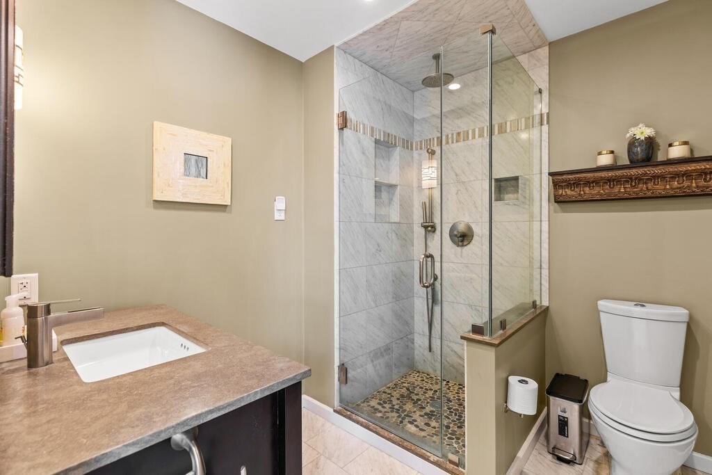 164 Marrett Road Lexington, MA 02421 - Photo 24 of 41 a bathroom with a granite countertop sink toilet and shower