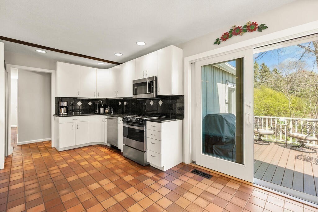 164 Marrett Road Lexington, MA 02421 - Photo 10 of 41 a kitchen with stainless steel appliances a stove a sink and a refrigerator