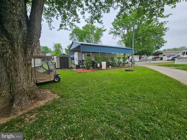 a view of a house with backyard sitting area and garden