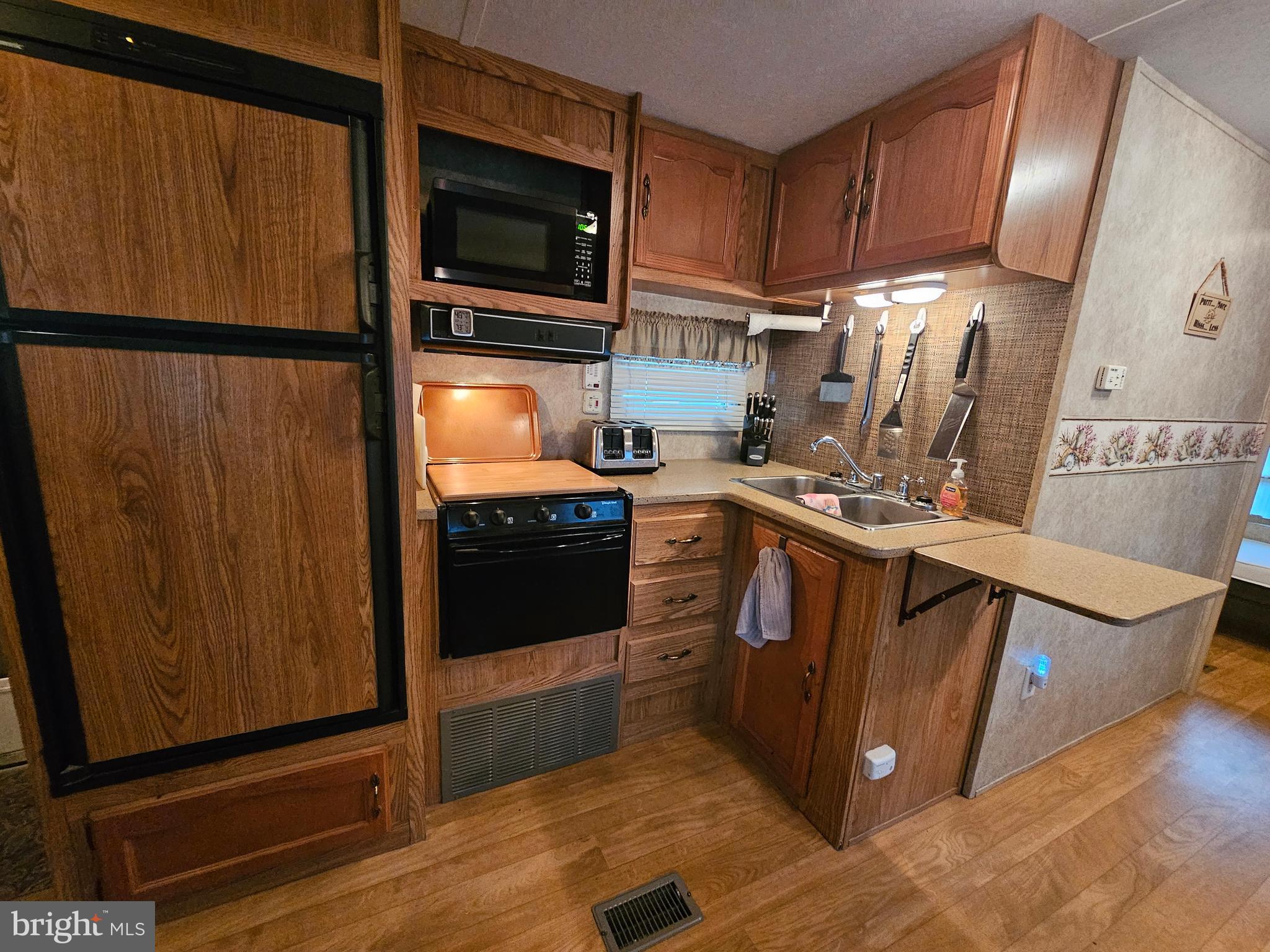 6 Boo Boo Boulevard Falling Waters, WV 25419 - Photo 10 of 43 a kitchen with stainless steel appliances granite countertop a stove a microwave and a refrigerator