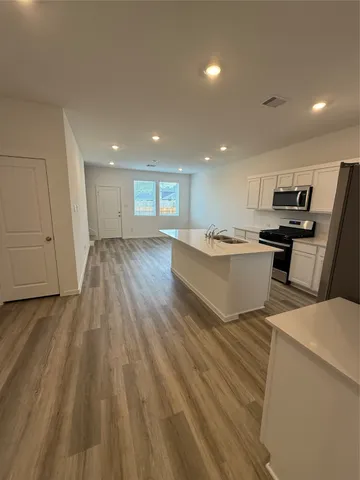a living room with stainless steel appliances kitchen island granite countertop furniture and a kitchen view