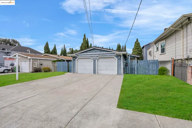 a front view of a house with a garden and yard