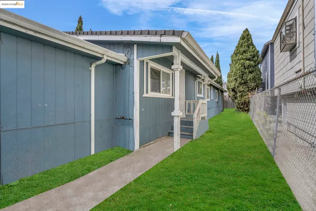 a view of an house with backyard space and garden
