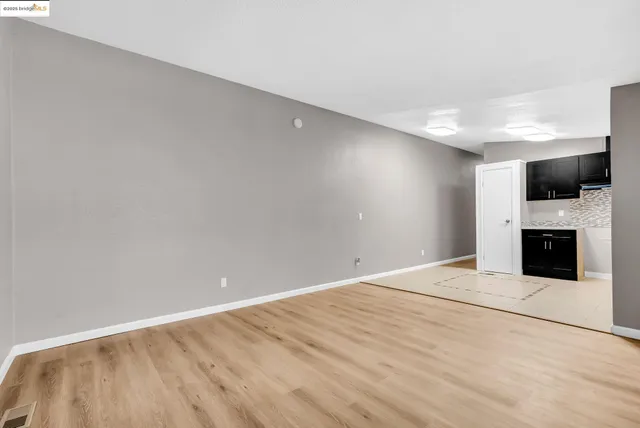 a view of an empty room with a fireplace