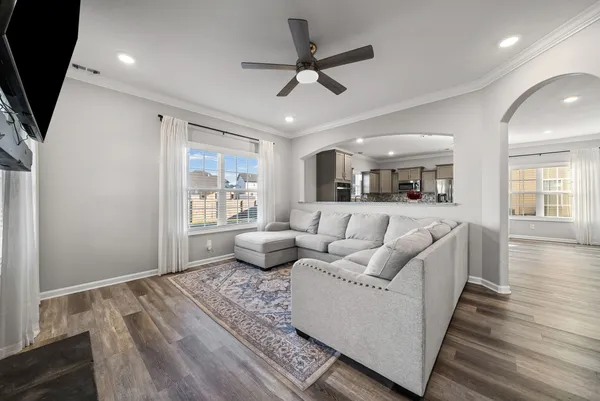 a living room with furniture and a view of bedroom