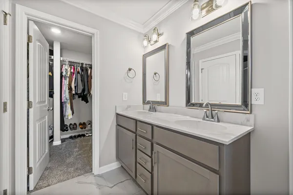 a view of walk in closet with clothes