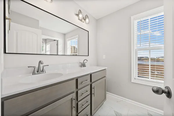 a bedroom with a bed and a ceiling fan