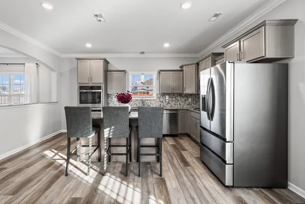 a kitchen with a sink stove and cabinets