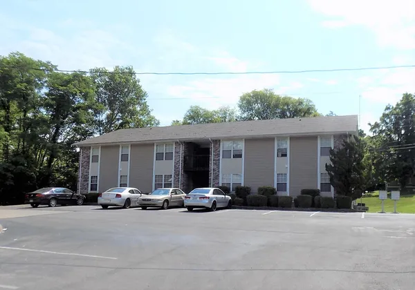 a couple of cars parked in front of house