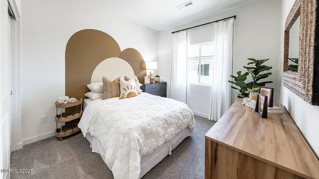 a bedroom with a bed and a potted plant