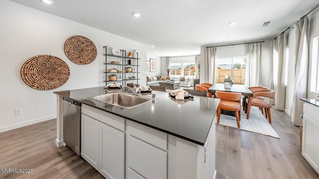 a view of a kitchen area with furniture and wooden floor