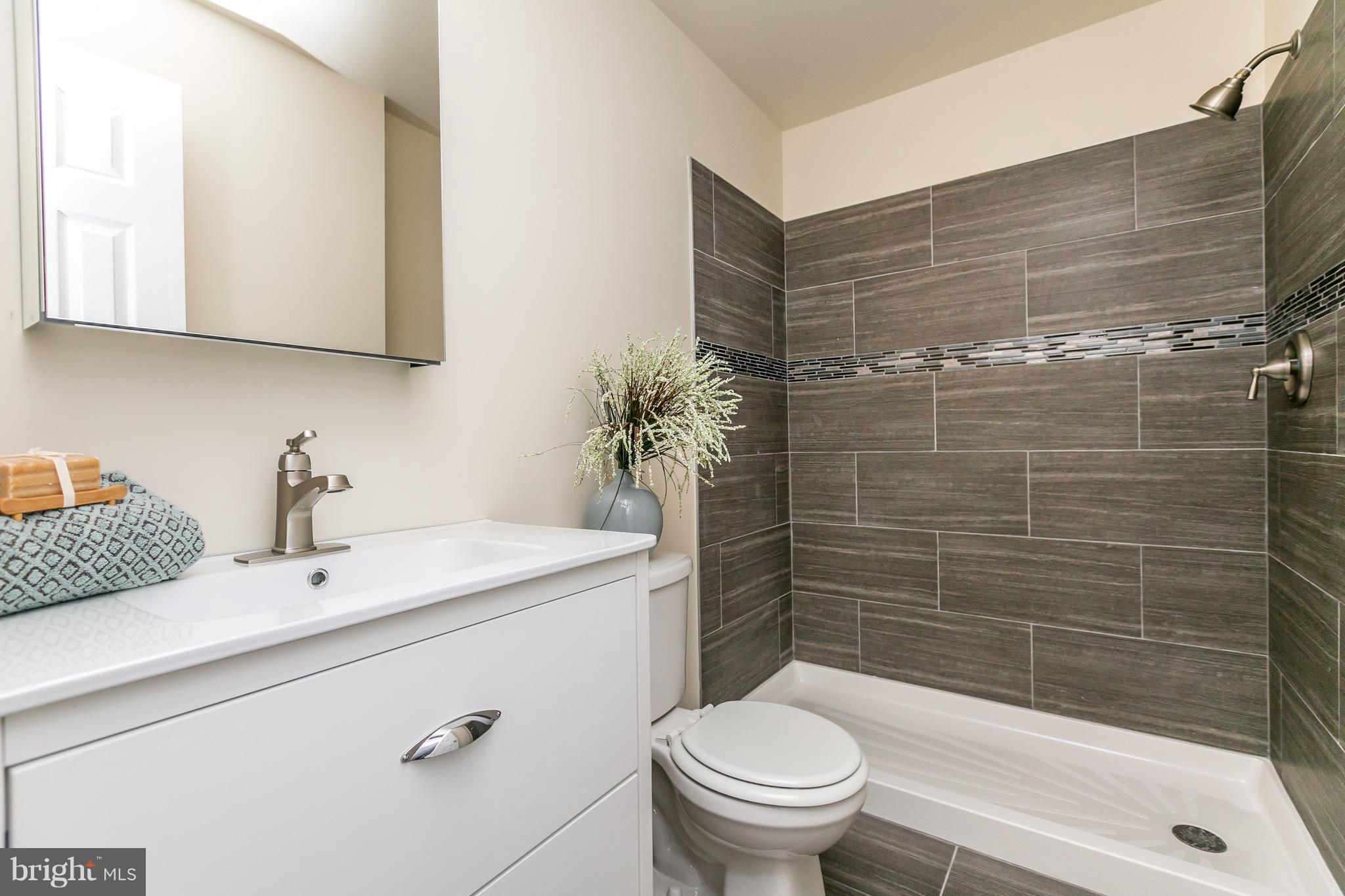 1205 Gettig Road Baltimore, MD 21237 - Photo 14 of 30 a bathroom with a sink a toilet and shower